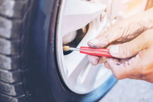 Man pumping air into a tyre valve